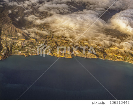 Aerial View Of Cloud-Covered Coastline And Cliffside Villages Over Mediterranean Sea Aerial View Of Cloud-Covered Coastline And Cliffside Villages Over Mediterranean Sea 136313442