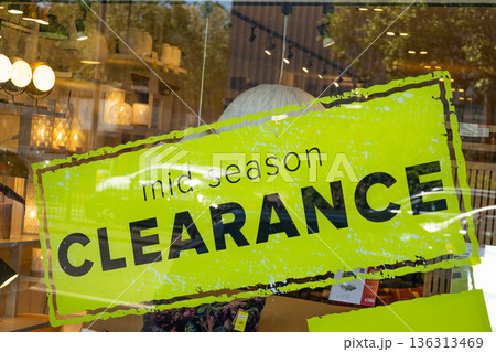 Mid season clearance sign on store window Mid season clearance sign on store window 136313469
