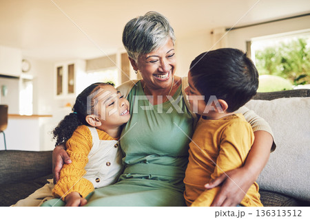 Hug, grandmother or happy kids on a sofa with love enjoying quality bonding time together in family home. Smile, affection or funny senior grandparent with children siblings on house couch laughing 136313512