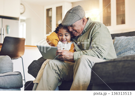 Girl kid, grandfather with tablet on sofa and relax together, watch cartoon or elearning games at home. Bonding, love and spending quality time, old man and female child with gadget and internet Girl kid, grandfather with tablet on sofa and relax together, watch cartoon or elearning games at home. Bonding, love and spending quality time, old man and female child with gadget and internet 136313513