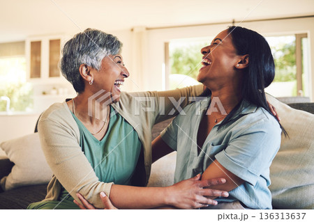 Funny, senior mother and hug daughter in home, bonding and laughing together. Happy, elderly mom and embrace woman, relax and smile with care, love and enjoying time on living room sofa with family. 136313637