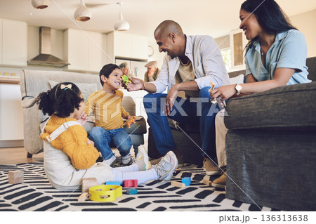 Family home, kids and parents with toys, living room and playful on floor with talking, laughing and games. Men, women and children with building blocks, development and learning in lounge in house Family home, kids and parents with toys, living room and playful on floor with talking, laughing and games. Men, women and children with building blocks, development and learning in lounge in house 136313638
