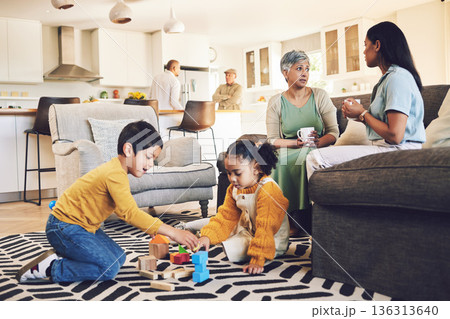 Family home, kids and siblings with toys, living room and play on floor with grandparents, parents or games. Men, women and children for building blocks, development and learning in lounge in house 136313640