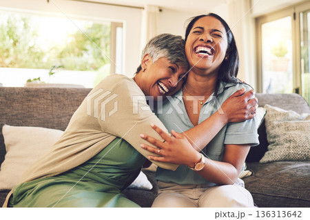 Senior mother, funny and hug woman in living room, bonding and laughing together. Happy, elderly mom and embrace person, relax and smile with care, love and enjoying time on home sofa with family. 136313642