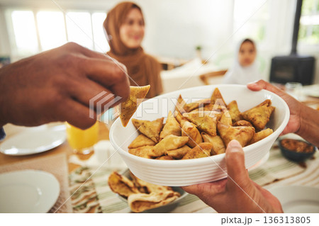 Food, samosa and muslim with hands of people at table for eid mubarak, Islamic celebration and lunch. Ramadan festival, culture and iftar with closeup of family at home for fasting, islam or religion Food, samosa and muslim with hands of people at table for eid mubarak, Islamic celebration and lunch. Ramadan festival, culture and iftar with closeup of family at home for fasting, islam or religion 136313805