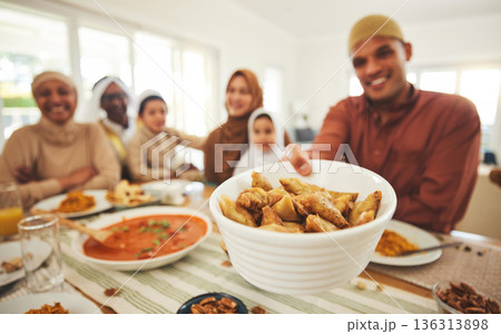 Food, offer and muslim with big family at table for eid mubarak, Islamic celebration and lunch. Ramadan festival, culture and iftar with people eating at home for fasting, islam and religion holiday 136313898