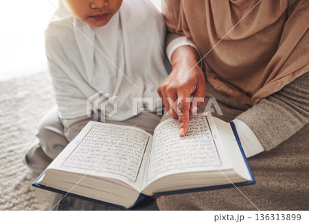Quran, Muslim child or parent hands reading for learning, Islamic knowledge and faith in Allah, god or culture. Spiritual books, home closeup or Arab person teaching kid worship, prayer or gratitude 136313899