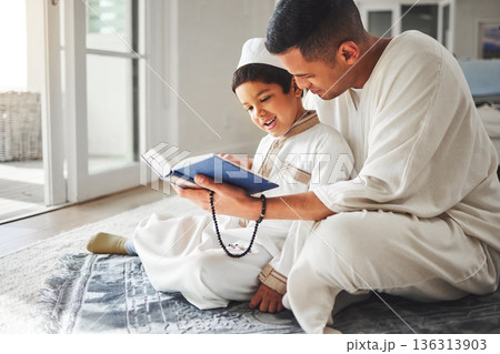 Quran, Muslim and father and happy kid praying to Allah, god or holy spirit for Arabic religion, faith and reading spiritual book. Prayer beads, home family study and Islamic dad teaching youth child 136313903