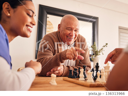 Senior man, nursing home and chess for game, competition and happy with friends, strategy and relax together. Elderly person, nurse and board for contest with mindset, excited smile or point at table 136313966