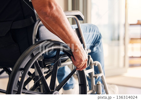 Man, hands and wheelchair for support, hope or travel in healthcare or medicare at home. Closeup of male or person with a disability moving on chair for mobility, surgery or wellness in the house 136314024
