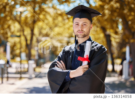 Graduation, diploma and arms crossed with man portrait with education paper and serious outdoor. Vision, certificate and male student with scholarship and university degree with graduate and study 136314058