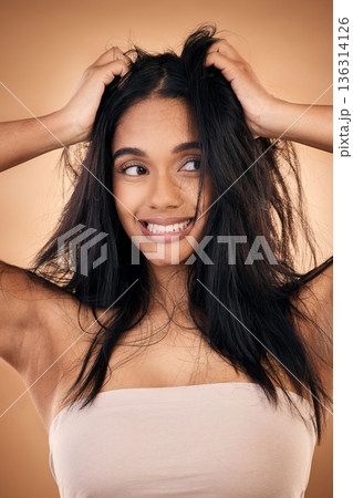 Mess, hair and face of woman in studio with haircare problem, damaged texture and split ends crisis. Salon, beauty and worried female person with hands on head for treatment, hygiene and cleaning 136314126