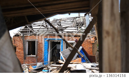 View to destroyed residential buildings at Kharkivska oblast. Ruined houses after bomb attacks on ukrainian territory from russia army. Consequences of russian invasion of Ukraine. Slow motion 136314158