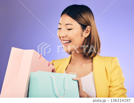 Check, shopping bag and young woman for fashion sale, discount or retail prize on studio, purple background. Excited model, asian person or happy customer with choice, giveaway and wealth or gift Check, shopping bag and young woman for fashion sale, discount or retail prize on studio, purple background. Excited model, asian person or happy customer with choice, giveaway and wealth or gift 136314197