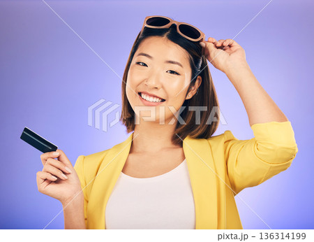 Credit card, shopping portrait and woman in sunglasses, retail banking and finance, e commerce or payment. Happy customer, fashion model or asian person for debit pay on studio purple background Credit card, shopping portrait and woman in sunglasses, retail banking and finance, e commerce or payment. Happy customer, fashion model or asian person for debit pay on studio purple background 136314199