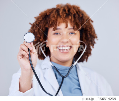 Healthcare, stethoscope and portrait of woman doctor in studio for hospital check up on grey background. Cardiology, health and face of lady cardiologist with heart, lungs and heartbeat medical tool Healthcare, stethoscope and portrait of woman doctor in studio for hospital check up on grey background. Cardiology, health and face of lady cardiologist with heart, lungs and heartbeat medical tool 136314239