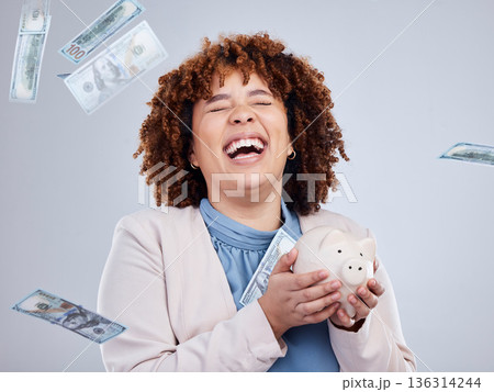 Happy woman with money rain, piggy bank and savings in studio, finance and budget with dollar investment. Happiness, growth and cash profit, salary bonus for girl with money box on white background. 136314244