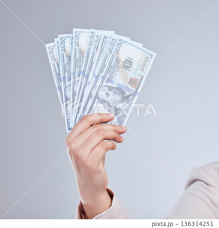 Money, hand and woman in studio with savings, success or cashback, reward and bonus on grey background. Cash, investment and female winner show casino, poker or gambling award with financial freedom Money, hand and woman in studio with savings, success or cashback, reward and bonus on grey background. Cash, investment and female winner show casino, poker or gambling award with financial freedom 136314251