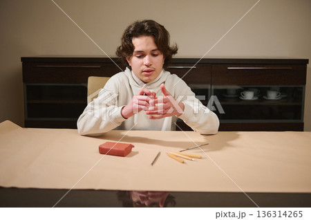 Young Boy Crafting Clay At Home, Focused On Hands, Creative Hobby Activity Young Boy Crafting Clay At Home, Focused On Hands, Creative Hobby Activity 136314265