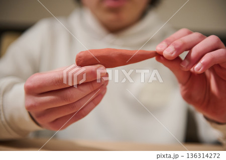 Child Molding Clay At Home, Hands Shaping Brown Dough In Focused Hobby Session Child Molding Clay At Home, Hands Shaping Brown Dough In Focused Hobby Session 136314272