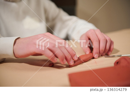 Child Hands Sculpting Red Clay At Home, Focused Hobby And Creativity In A Quiet Studio 136314279