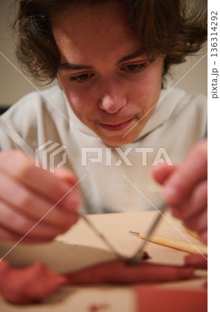 Young Boy Focused On Clay Sculpting At Home With Tools And Clay Young Boy Focused On Clay Sculpting At Home With Tools And Clay 136314292