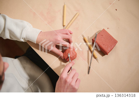 Young Artist At Home Molding Clay With Tools, Creating Sculptures In A Hobby Studio 136314318