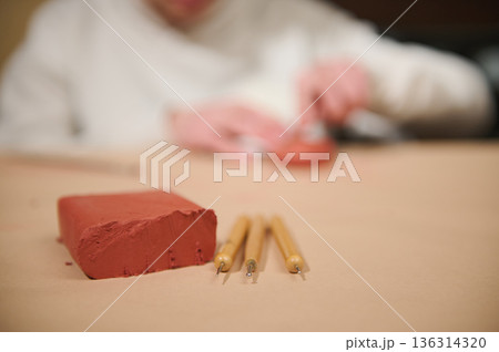 Young Creator Molding Red Clay With Fine Tools At Home For Craft Project 136314320