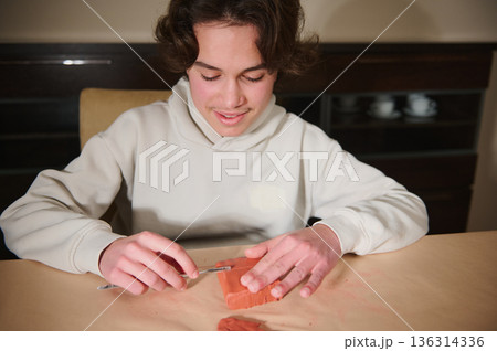 Young Boy Molding Clay At Home, Focused On Craft Project And Creative Hobby 136314336