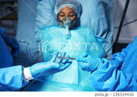 Hands, scissors and surgery with a team of doctors operating on a patient in the hospital emergency room. Medical, equipment or operation with medicine professionals in a clinic theatre from above Hands, scissors and surgery with a team of doctors operating on a patient in the hospital emergency room. Medical, equipment or operation with medicine professionals in a clinic theatre from above 136314410