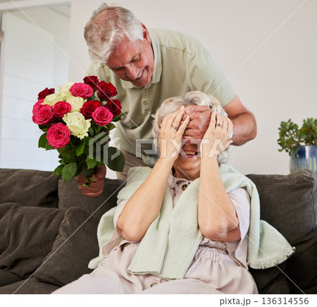Senior couple, surprise and flowers gift for love and valentines day in a home. Living room couch, closed eyes and smile with elderly woman and man together in retirement with bouquet in a house 136314556