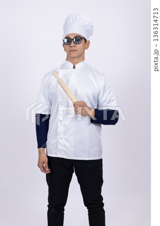 Professional male chef in white uniform and glasses posing Professional male chef in white uniform and glasses posing 136314713
