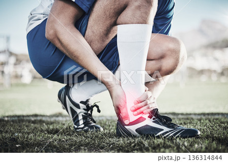 Injury, sports and hand of a man on foot pain, soccer emergency and accident while training. Fitness, problem and an athlete or football player with inflammation or a swollen muscle on the field Injury, sports and hand of a man on foot pain, soccer emergency and accident while training. Fitness, problem and an athlete or football player with inflammation or a swollen muscle on the field 136314844