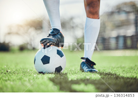 Legs, sports or man with a soccer ball on a field for exercise, fitness and training for a competition outdoors. Football club, ready or boots of player in a game event or match in stadium on grass Legs, sports or man with a soccer ball on a field for exercise, fitness and training for a competition outdoors. Football club, ready or boots of player in a game event or match in stadium on grass 136314853