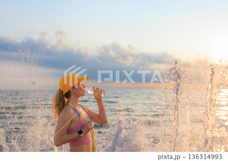 Fit woman jumping rope at the beach during summer vacation 136314993