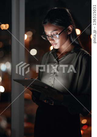 Night, work or woman reading on tablet for research, project or planning a proposal in office building, startup or professional employee. Overtime, working or search on internet, online communication 136315031