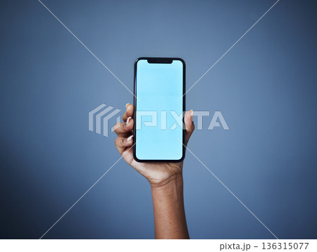 Phone, mockup and woman hand in studio with space for plan, menu or information, contact or space on dark background. Blue screen, smartphone and person show text, product placement or social media 136315077