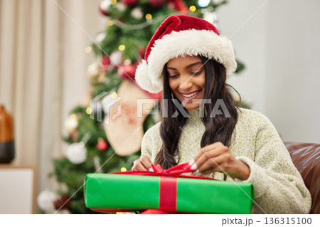 Woman, Christmas and open present with smile, celebrate holiday with happiness and wrapped box with ribbon. Special event, female person at home with gift giving and package, festive and xmas Woman, Christmas and open present with smile, celebrate holiday with happiness and wrapped box with ribbon. Special event, female person at home with gift giving and package, festive and xmas 136315100