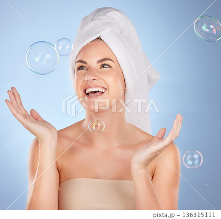 Happy, studio face and woman with bubbles for skincare, body cleaning bath or morning hygiene wash. Bathroom, beauty happiness or person with smile, wellness or self care hydration on blue background 136315111