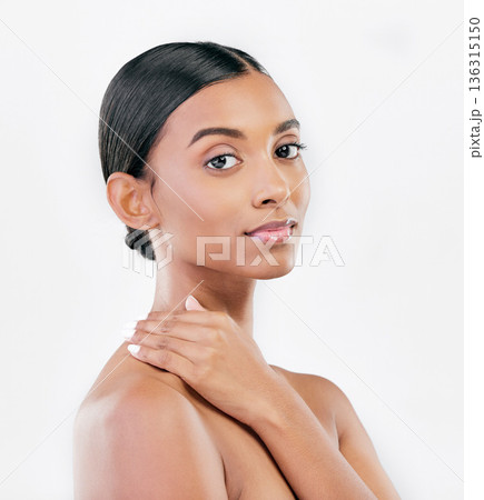 Touch, beauty and face portrait of a woman with natural skin glow isolated on a white background. Dermatology, makeup and cosmetics of Indian female model for facial shine or self care in studio 136315150