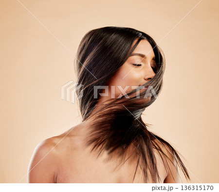Woman, shake hair and beauty with growth, texture and shine with natural cosmetics on studio background. Indian female model, satisfied with salon treatment and Brazilian, hairstyle and haircare Woman, shake hair and beauty with growth, texture and shine with natural cosmetics on studio background. Indian female model, satisfied with salon treatment and Brazilian, hairstyle and haircare 136315170