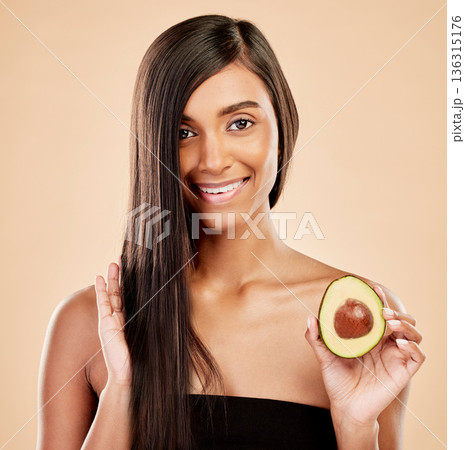 Portrait, woman and avocado for hair, beauty or cosmetic treatment of natural growth on studio background. Happy indian female model, green fruits and vegan dermatology for keratin and aesthetic glow Portrait, woman and avocado for hair, beauty or cosmetic treatment of natural growth on studio background. Happy indian female model, green fruits and vegan dermatology for keratin and aesthetic glow 136315176