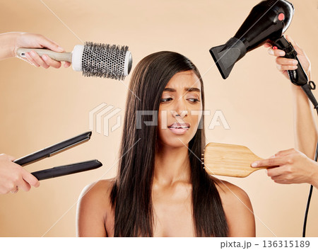 Hair, electric tools and damage of woman for beauty, heat treatment and stress on studio background. Indian female model, worry and anxiety for aesthetic equipment of brush, hairdryer and flat iron Hair, electric tools and damage of woman for beauty, heat treatment and stress on studio background. Indian female model, worry and anxiety for aesthetic equipment of brush, hairdryer and flat iron 136315189