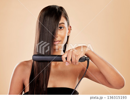 Beauty, flat iron and hair care of a woman in studio with natural glow and shine. Straightener, cosmetics and wellness of Indian person for hairdresser, hot tools or salon results on beige background 136315193