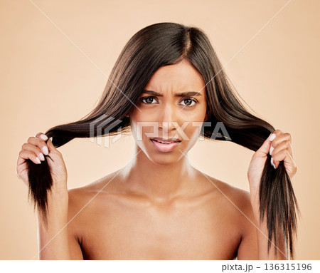 Hair, damage and portrait of woman in stress on studio background for dry texture, aesthetic beauty and cosmetics problem. Face, frustrated indian female model or anxiety for hairstyle with split end 136315196