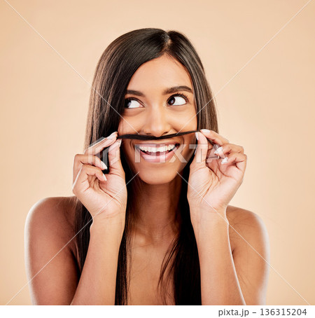 Face, beauty and hair mustache with a woman in studio on a cream background for keratin treatment. Skincare, haircare and funny with happy young female looking playful at the salon or hairdresser 136315204