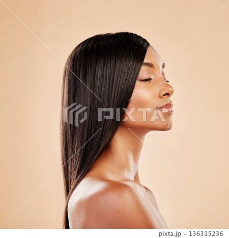 Beauty, hair care and profile of a woman in studio with natural glow and shine. Hairstyle, cosmetics and wellness of Indian person for hairdresser, makeup or salon results on a beige background 136315236