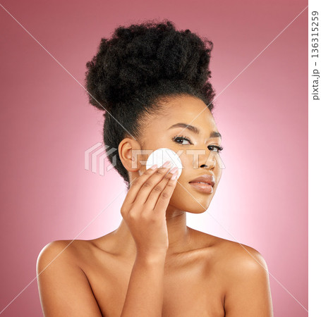 Black woman, cotton pad and portrait with makeup, dermatology and skincare on a studio background. Female person, shine and model with cosmetics, aesthetic and cleaning with beauty, glow and patches Black woman, cotton pad and portrait with makeup, dermatology and skincare on a studio background. Female person, shine and model with cosmetics, aesthetic and cleaning with beauty, glow and patches 136315259
