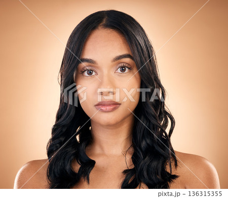 Face, serious woman and hair care, beauty and curly isolated in studio on a brown background. Portrait, natural skincare and female model with salon treatment for aesthetic, wellness and hairstyle Face, serious woman and hair care, beauty and curly isolated in studio on a brown background. Portrait, natural skincare and female model with salon treatment for aesthetic, wellness and hairstyle 136315355