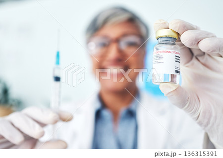 Hands, vaccine and woman doctor in hospital with medical, innovation or cure for smallpox in closeup. Vaccination, vial and health expert with syringe for healthcare, injection or covid treatment 136315391